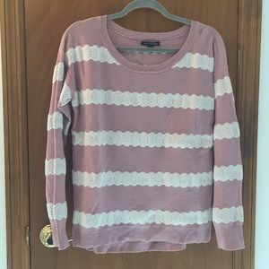 Pink sweater with white lace-like knit detail